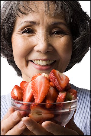 simsearch:640-02949943,k - senior woman with a bowl of strawberries Stock Photo - Premium Royalty-Free, Code: 640-02948503