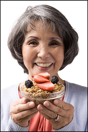 simsearch:640-02949943,k - senior woman with a bowl of cereal and strawberries Stock Photo - Premium Royalty-Free, Code: 640-02948515