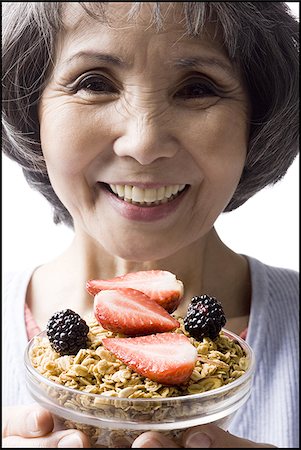 simsearch:640-02949943,k - senior woman with a bowl of cereal and strawberries Stock Photo - Premium Royalty-Free, Code: 640-02948516