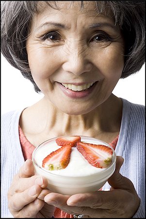 simsearch:640-02949943,k - senior woman with a bowl of cereal and strawberries Stock Photo - Premium Royalty-Free, Code: 640-02948513