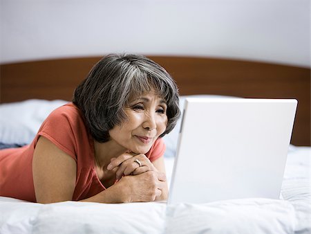 senior woman using a laptop computer Stock Photo - Premium Royalty-Free, Code: 640-02948575