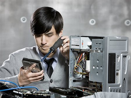 man working on a computer Stock Photo - Premium Royalty-Free, Code: 640-02948758