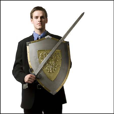 shield sword - businessman holding a sword and shield Stock Photo - Premium Royalty-Free, Code: 640-02948897