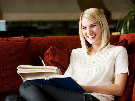 simsearch:640-08089533,k - woman studying on a red sofa Stock Photo - Premium Royalty-Free, Code: 640-02949575