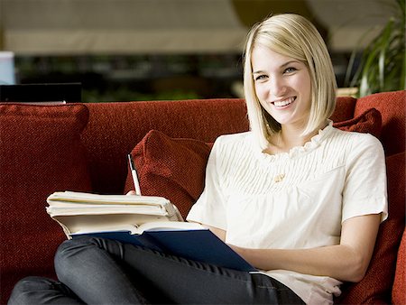 simsearch:640-08089533,k - woman studying on a red sofa Stock Photo - Premium Royalty-Free, Code: 640-02949576