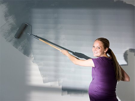 woman painting a room Stock Photo - Premium Royalty-Free, Code: 640-02949878