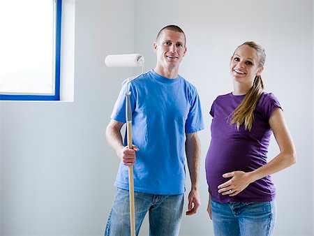 short haired women pregnant - couple painting a room Stock Photo - Premium Royalty-Free, Code: 640-02949880