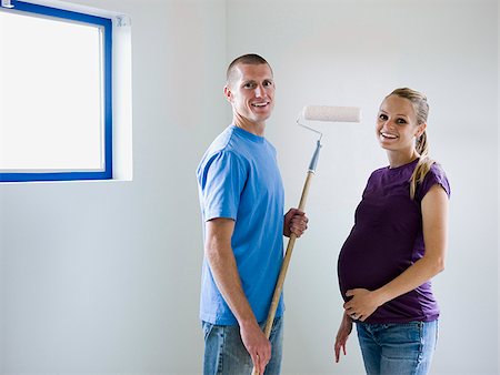 short haired women pregnant - couple painting a room Stock Photo - Premium Royalty-Free, Code: 640-02949881