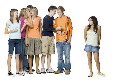 one young woman standing apart from a group of teenagers Stock Photo - Premium Royalty-Free, Code: 640-02950007