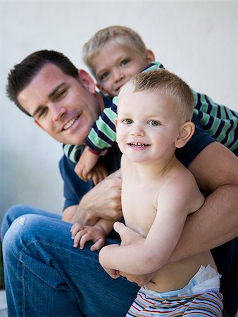 dad son playing wrestling - father and two sons Stock Photo - Premium Royalty-Free, Code: 640-02950062