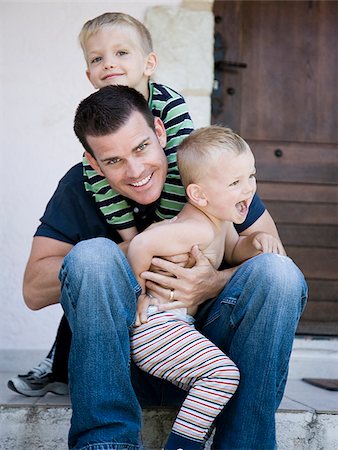 dad son playing wrestling - father and two sons Stock Photo - Premium Royalty-Free, Code: 640-02950063