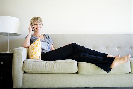 simsearch:640-08089386,k - woman on the couch using cell phone Stock Photo - Premium Royalty-Free, Code: 640-02950168