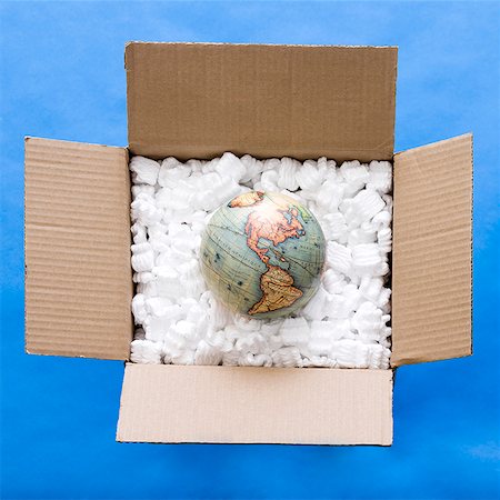 shipping package - globe in a box full of packing material Stock Photo - Premium Royalty-Free, Code: 640-02950264