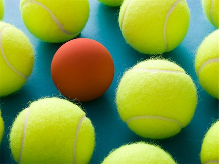 tennis balls and a racquetball against a blue background Stock Photo - Premium Royalty-Free, Code: 640-02950260