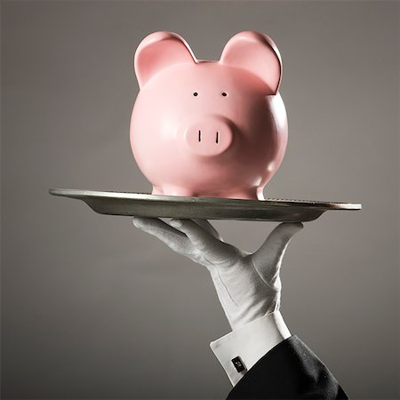 piggy bank hand - piggy bank on a platter Stock Photo - Premium Royalty-Free, Code: 640-02950332