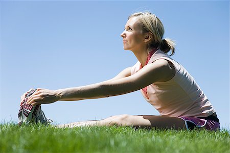 simsearch:640-02947561,k - woman sitting on the grass stretching Stock Photo - Premium Royalty-Free, Code: 640-02950470