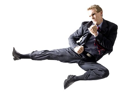 businessman doing a karate kick Foto de stock - Sin royalties Premium, Código: 640-02950503