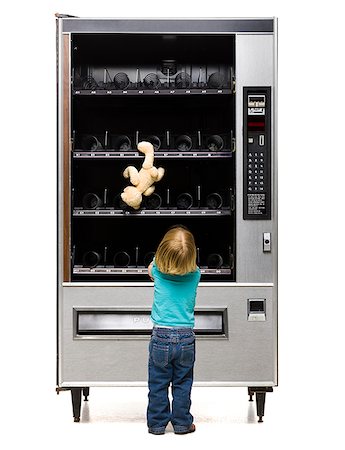 person at vending machine - girl buying a teddy bear from a vending machine Stock Photo - Premium Royalty-Free, Code: 640-02950604