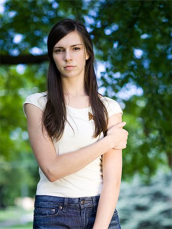 sad adult looking at camera - woman in a white shirt Stock Photo - Premium Royalty-Free, Code: 640-02950733