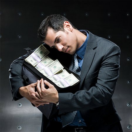 simsearch:640-02951546,k - businessman holding a bag of money Stock Photo - Premium Royalty-Free, Code: 640-02950896