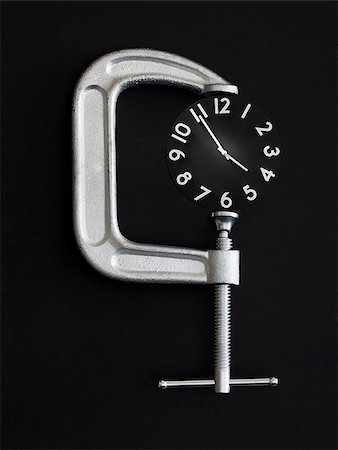 clock in a clamp Stock Photo - Premium Royalty-Free, Code: 640-02951076