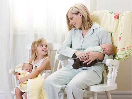 rocking chair - mother and daughter each holding a newborn baby Stock Photo - Premium Royalty-Free, Code: 640-02951225