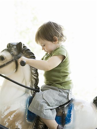 little boy on a rocking horse Stock Photo - Premium Royalty-Free, Code: 640-02951252