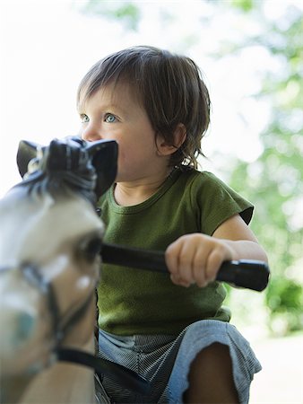 little boy on a rocking horse Stock Photo - Premium Royalty-Free, Code: 640-02951253