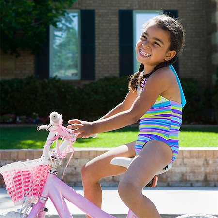 riding bicycles hispanic - girl riding her bike Stock Photo - Premium Royalty-Free, Code: 640-02951651