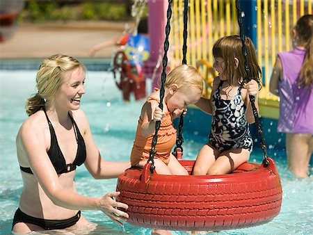 children on a tire swing at a waterpark Stock Photo - Premium Royalty-Free, Code: 640-02951748