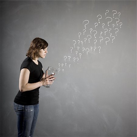 people holding chalkboards in pictures - woman with a jar full of question marks Stock Photo - Premium Royalty-Free, Code: 640-02951846