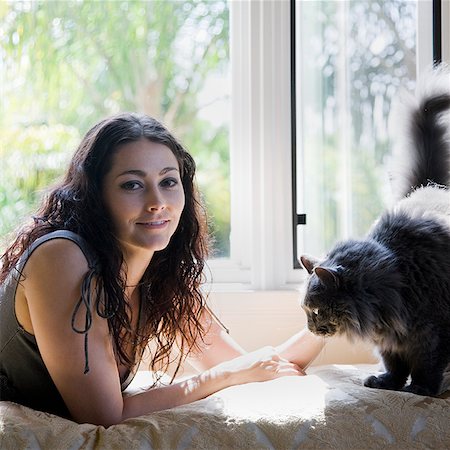 woman on a window bench with her cat Stock Photo - Premium Royalty-Free, Code: 640-02951900