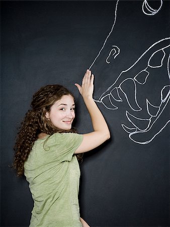 pet illustration - woman standing with a chalk dragon Stock Photo - Premium Royalty-Free, Code: 640-02952007