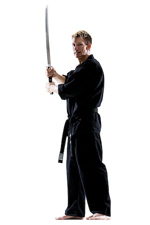 man in a black karate gi practicing martial arts Foto de stock - Sin royalties Premium, Código: 640-02952107