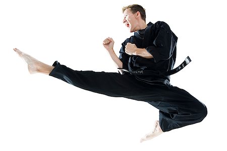 man in a black karate gi practicing martial arts Fotografie stock - Premium Royalty-Free, Codice: 640-02952102