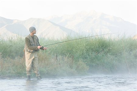 fly fisherman fishing in a mountain river Stock Photo - Premium Royalty-Free, Code: 640-02952365