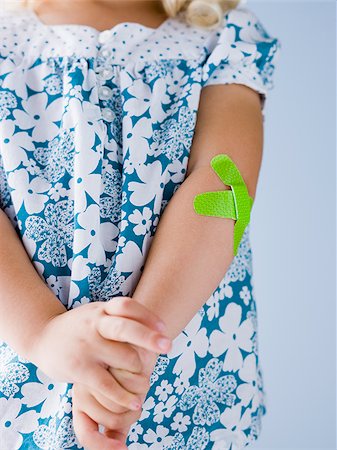 little girl with a bandaid on her arm Foto de stock - Royalty Free Premium, Número: 640-02952405