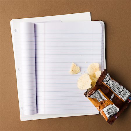 potatochips - notebook with a bag of chips spilled onto an empty page Stock Photo - Premium Royalty-Free, Code: 640-02952696