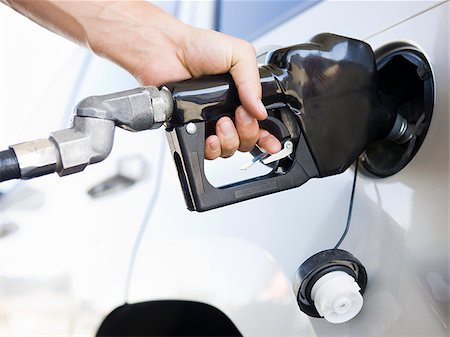 hand pumping gas into a car Stock Photo - Premium Royalty-Free, Code: 640-02952747