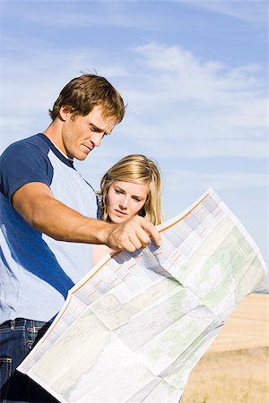 simsearch:640-02952767,k - couple looking at a map on the side of the road Stock Photo - Premium Royalty-Free, Code: 640-02952769