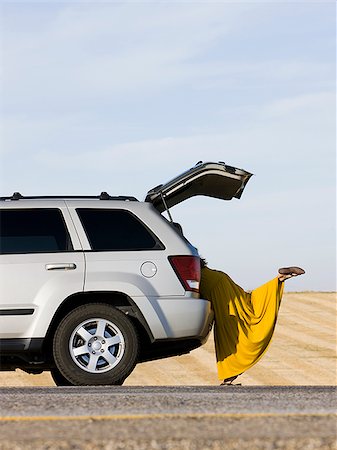 simsearch:640-02952767,k - woman hanging out the back of her car on the side of the road Stock Photo - Premium Royalty-Free, Code: 640-02952779