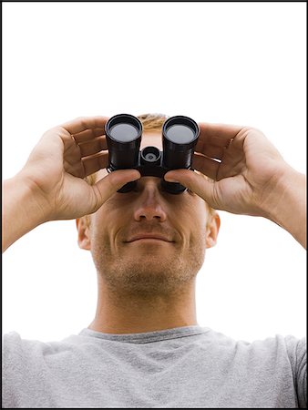 man looking through binoculars Stock Photo - Premium Royalty-Free, Code: 640-02952847