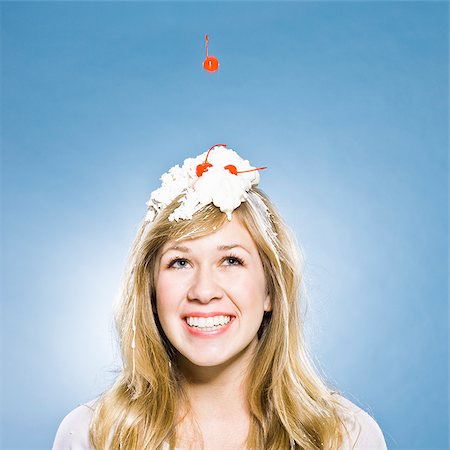 smile woman ice cream messy - woman with whipped cream and a cherry on her head Stock Photo - Premium Royalty-Free, Code: 640-02953096