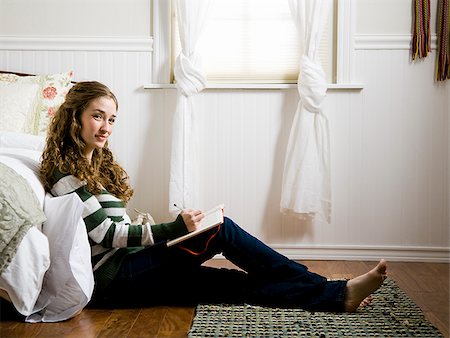 woman sitting in her room writing in a journal Stock Photo - Premium Royalty-Free, Code: 640-02953102