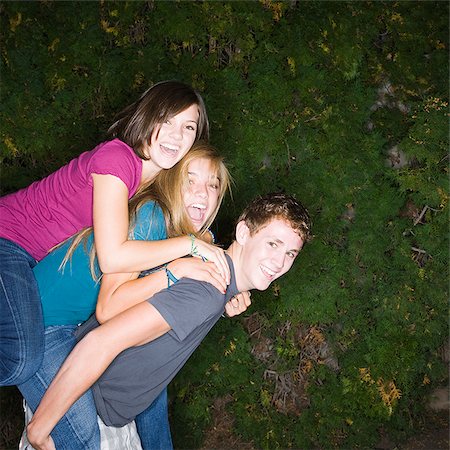 three teenagers climbing on each other Stock Photo - Premium Royalty-Free, Code: 640-02953166