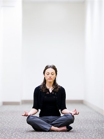 businesswoman sitting on the floor meditating Stock Photo - Premium Royalty-Free, Code: 640-02953199