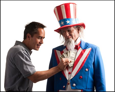 rimborso - man taking money out of uncle sam's coat Fotografie stock - Premium Royalty-Free, Codice: 640-02953245