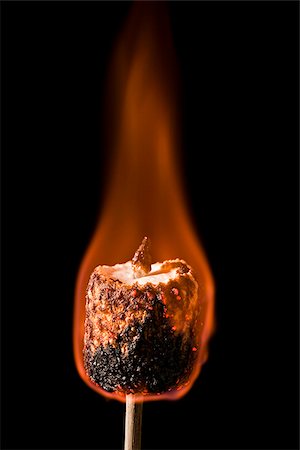 marshmallow burning on a stick Stock Photo - Premium Royalty-Free, Code: 640-02953401