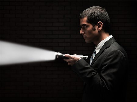 spying person - businessman holding a flashlight Stock Photo - Premium Royalty-Free, Code: 640-02953491