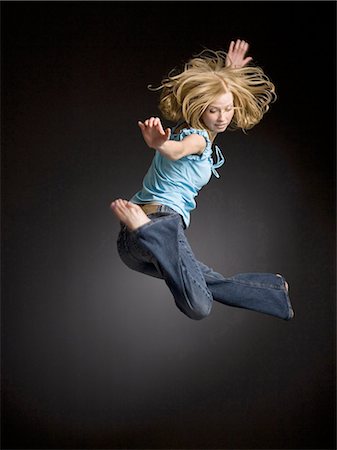 Person leaping in the air Stock Photo - Premium Royalty-Free, Code: 640-03255436